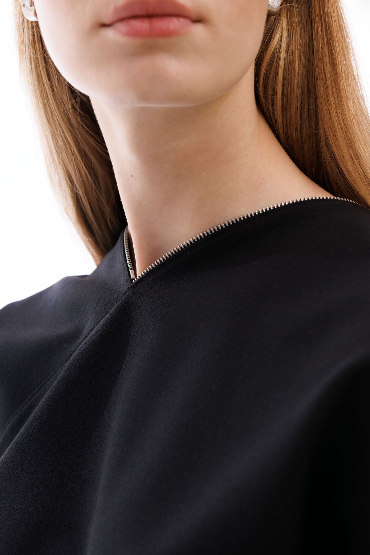 A606 structured black dress with sculptural shoulder and clean silhouette